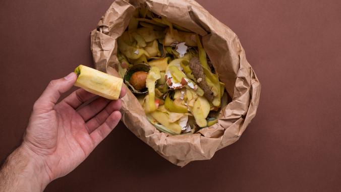 Food waste going into paper bag